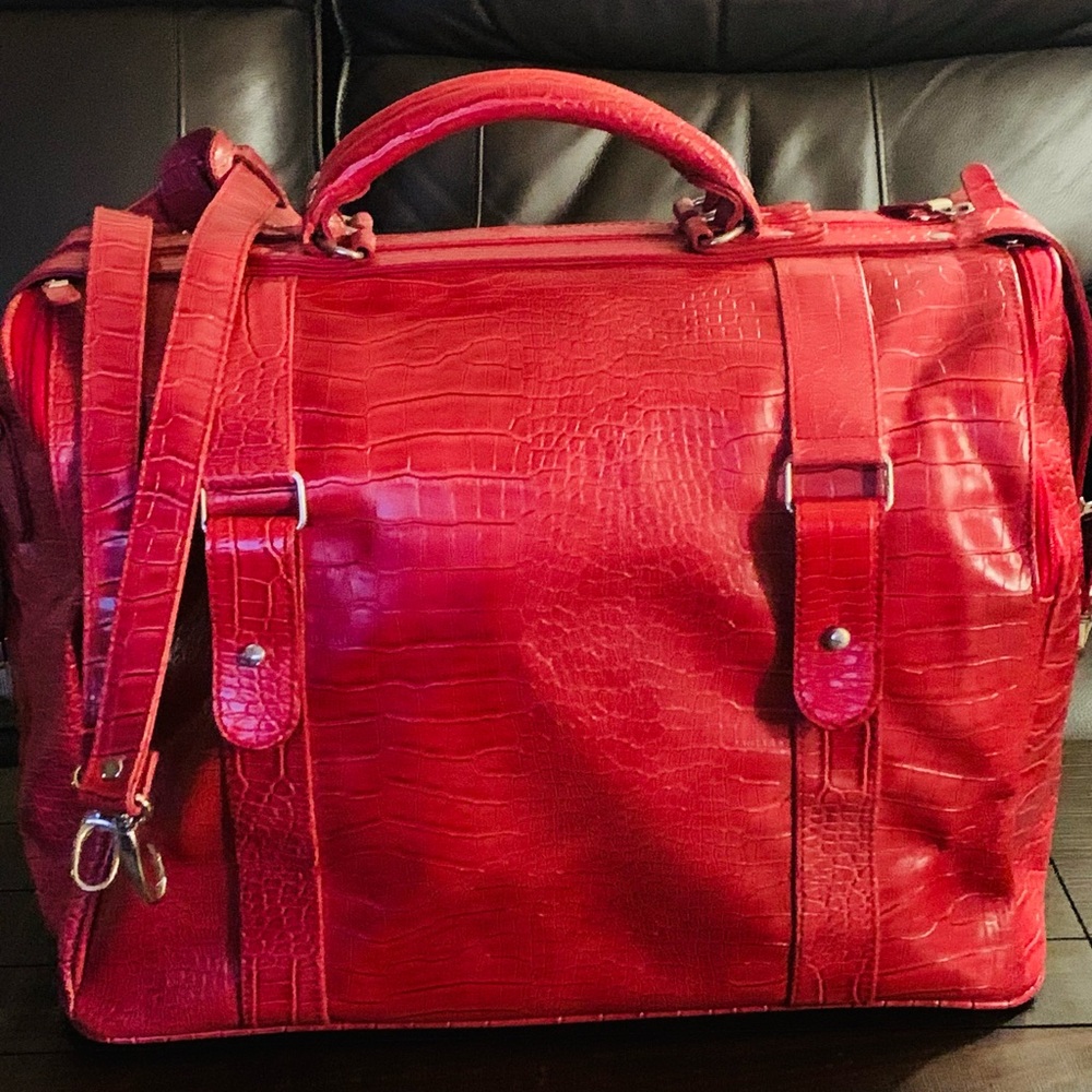 Bath & Body Works red faux croc duffel bag with dual handles and strap.